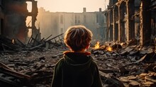 Children Stands In Front Of A Destroyed House, He Looks At The Destroyed Building, Rear View.