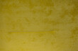 Yellow velvet fabric texture used as the background. Empty yellow fabric background of soft and smooth textile. There is space for text.