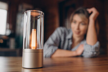 A Table Smart Lamp, A Woman On A Blurred Background.