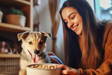 Loving Smiling Pretty Young Woman Feeding Cute Dog With A Dry Food At Cozy Home. Healthy Nutrition Full Of Vitamins And Minerals Dog Food. Caring For Pets