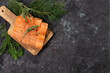 Salmon. Fresh raw salmon fish fillet with cooking ingredients, herbs and lemon on black background