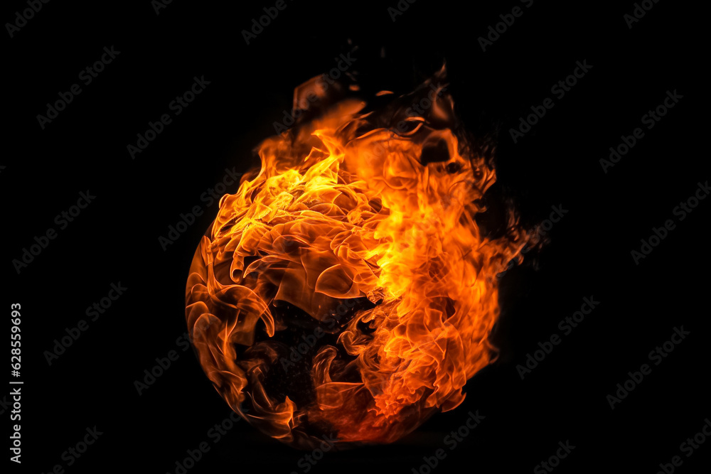 The ball of fire appears almost suspended in the darkness, its flames ...