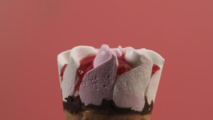Wall Mural - Strawberry ice cream in waffle cups. Ice cream on a pink background.