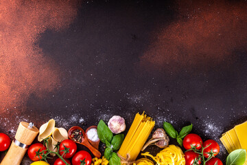 Various pasta with spices and ingredients for cooking. Preparation dinner, lunch background with fresh basil, tomatoes, spices, garlic and different sort and types of italian Mediterranean pasta