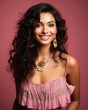 © AberrantRealities - beautiful indian woman with long curly hair wearing a pink top and gold jewelry