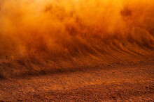 Dust Kicked Up By A Race Car On A Dirt Track 