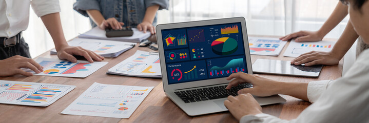 Fototapete - Panorama shot analyst team utilizing BI Fintech to analyze financial report with laptop. Businesspeople analyzing BI power dashboard displayed on laptop screen for business insight. Scrutinize