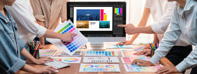 Leinwandbilder - Graphic designer brainstorming logo and graphic art at busy artistic workshop, laptop display workspace. Experimenting color palette and pattern for creative design. Panorama shot. Scrutinize