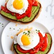 Sliced avocado toast on whole grain bread with a poached egg and red pepper flakes