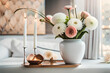 Bouquet of white flowers in a vase, candles on vintage copper tray, wedding home decor on a table