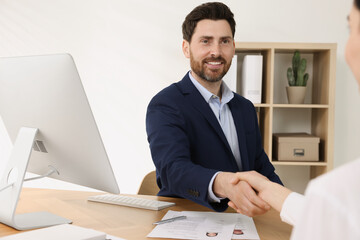 Poster - Human resources manager shaking hands with applicant during job interview in office