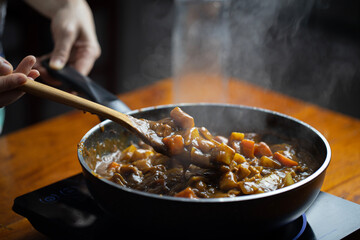 Delicious Massaman Thai Food Cooking on Hot Pan - Authentic Cuisine from Thailand.