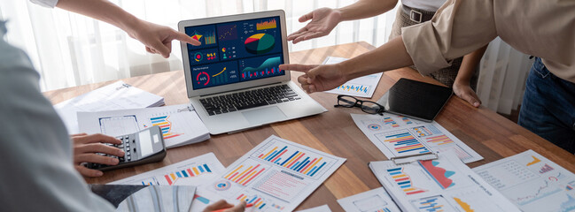 Fototapete - Panorama shot analyst team utilizing BI Fintech to analyze financial report with laptop. Businesspeople analyzing BI power dashboard displayed on laptop screen for business insight. Scrutinize