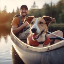 A Young Man Rowing A Canoe With His Aspin Dog In Sunny Autumn Weather. Active Pets, Happy Dog And Owner On An Backcountry Adventure.