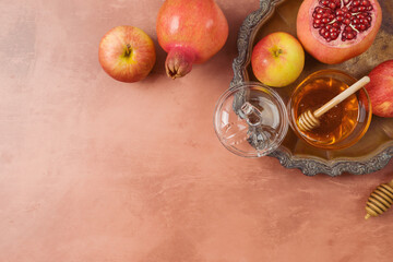 Jewish holiday Rosh Hashanah flat lay composition with honey, apple and pomegranate on vintage background. Top view