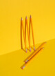 Pencils on a yellow background. Minimalism, conceptual business or education photo, creative layout