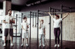Healthy family concept. Mom, dad and two sons teenagers with sports equipment posing in gym. Spending time together, Active lifestyle