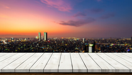  Wood table front view with blank city sunset background for product display