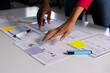 © Wavebreak Media - Hands of diverse male and female colleagues standing at desk discussing documents