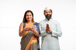 © Niks Ads - Indian couple begin new start up and woman doing inauguration.