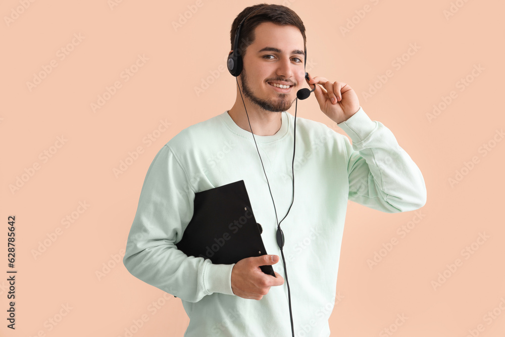 Male technical support agent with clipboard on beige background