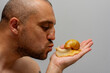 A man kisses an African snail