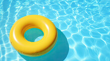 Inflatable Swim Ring Floating In The Blue Water Of The Swimming Pool In A Summer Vibe