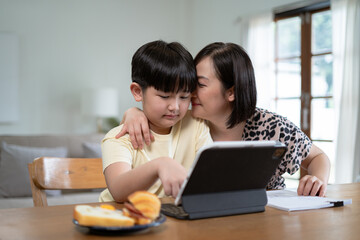 Happy family mom and son reading a book on holiday