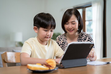 Happy family mom and son reading a book on holiday