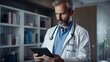 © Bojan - Portrait of mature male doctor with digital tablet and stethoscope working in hospital office.