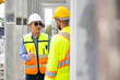 © NVB Stocker - building and construction worker, Hiapanic latin male wearing safety hard hat helmet standing at Prefabricated concrete walls Industry Manufacturing Factory. Unity and teamwork