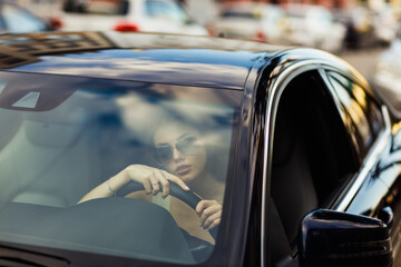 Happy woman driver at car smiling. Cute young happy brunette female driving car vehicle