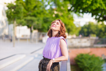 Wall Mural - Beautiful successful middle aged woman posing on the street photo shoot