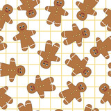 Fototapeta Pokój dzieciecy - Seamless pattern of gingerbread man. Winter homemade sweets on white and yellow mesh background. Christmas design.