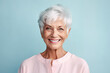 Beautiful elderly woman with gray hair smiling at the camera. Happy old age concept