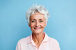 Beautiful elderly woman with gray hair smiling at the camera. Happy old age concept