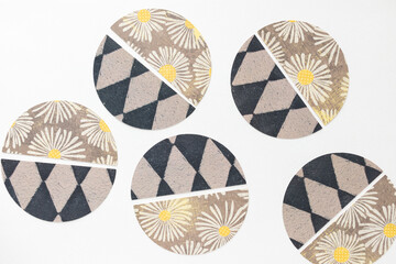 Sticker - machine-cut paper semi circle shapes arranged as round balls on blank paper