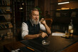 © Nomad_Soul - Pensive senior business man smoking cigar while sitting at work table