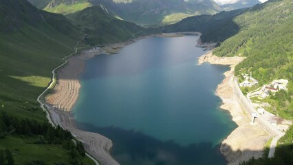 Sticker - Aerial of a beautiful lake surrounded by big mountains covered in green forests