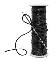 Plastic Spool With Black Synthetic Threads Close-up. Needle And Thread