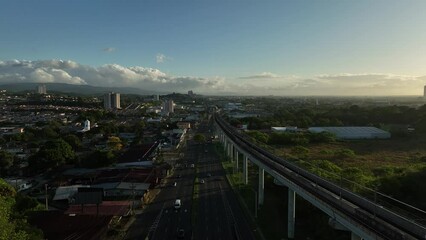 Sticker - Aerial video of a road and a bridge surrounded by the city and a green field