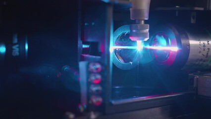 Wall Mural - closeup of a purple laser cutting quantum engineering machine
