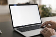 © fizkes - Empty white laptop display on work table of mature business freelance woman. Cropped shot of senior customer lady typing on computer with copy space on blank screen. Cropped close up shot