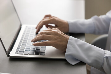 Canvas Print - Hands of mature businesswoman typing on laptop keyboard, working at office table with computer, using modern digital device, Internet technology for job, online education. Close up cropped shot