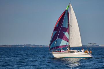 Sailing yacht regatta. Many sailing yachts in a row. sailing yachts under gennaker, speaker, genoa