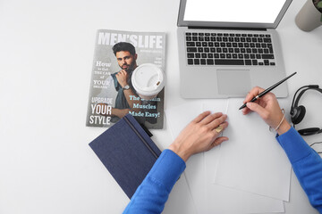 Sticker - Female hands with modern laptop, notebook and magazine at white table