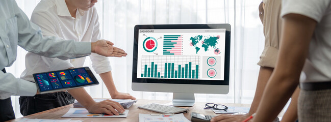 Fototapete - Panorama shot analyst team utilizing BI Fintech to analyze financial report with laptop. Businesspeople analyzing BI power dashboard displayed on laptop screen for business insight. Scrutinize