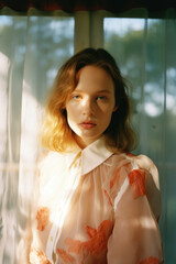 portrait of young thoughtful white caucasian woman by window with light and shadows in old vintage portra film look cinematic grainy editorial fashion magazine style gen z 