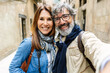 © Xavier Lorenzo - Portrait of senior attractive couple smiling at camera at city street. Mature people taking self portrait on summer vacation.