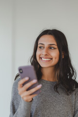 Wall Mural - Portrait of confident indian business woman wearing casual clothes holding smartphone